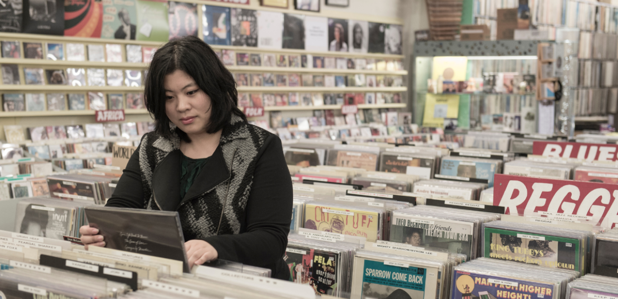 A photograph of Dr Cynthia Liem browsing records in a shop